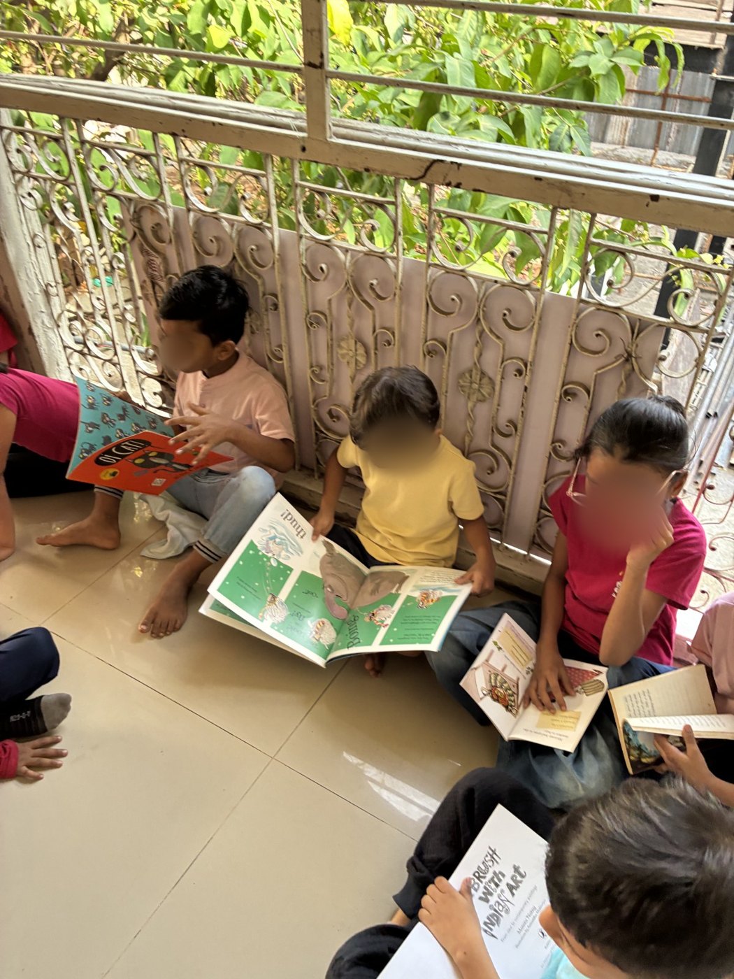 Children read picture books by a window