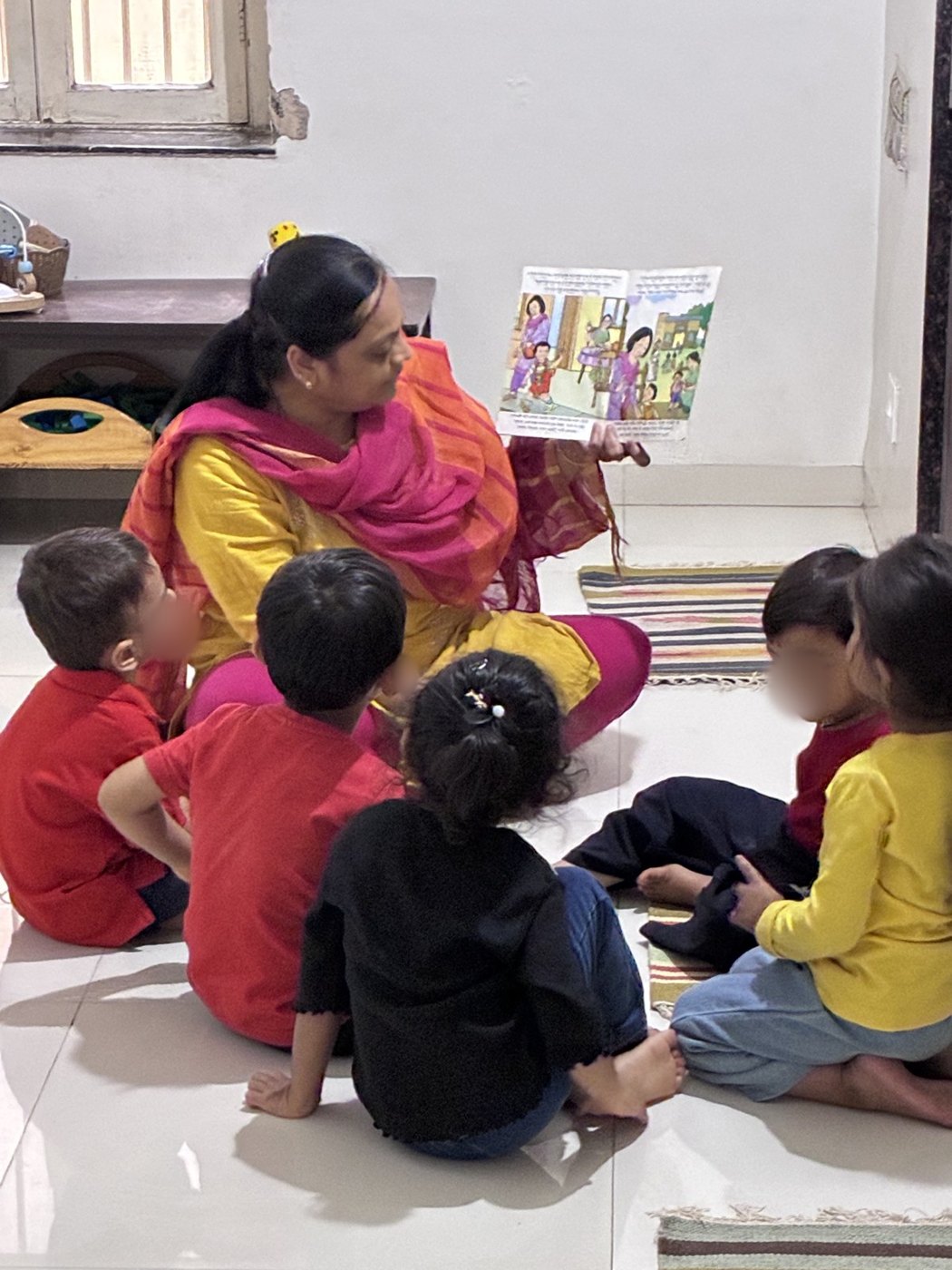 An educator reads a picture book to a group of young children