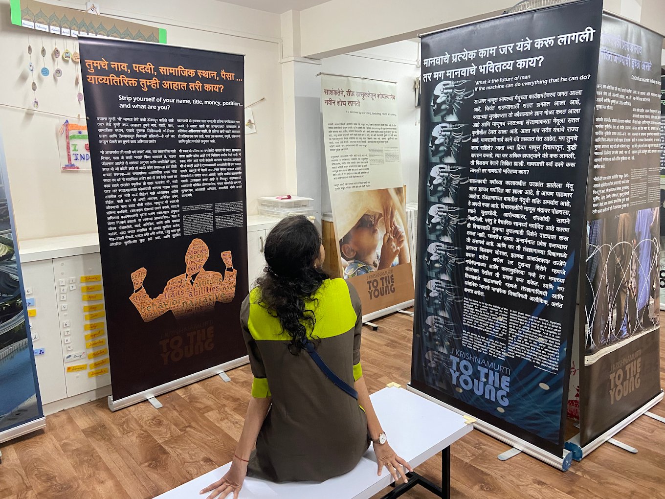 A visitor looks at panels in the Krishnamurti picture exhibition